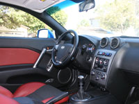 2007 Hyundai Tiburon SE V6 Interior, with Red Leather Seat Bolsters, Leather-Wrapped Steering Wheel and Aluminum Foot Pedals